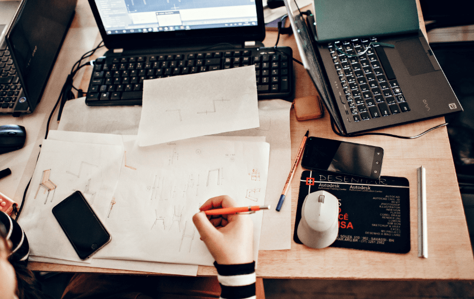 A first person perspective of someone working at a desk