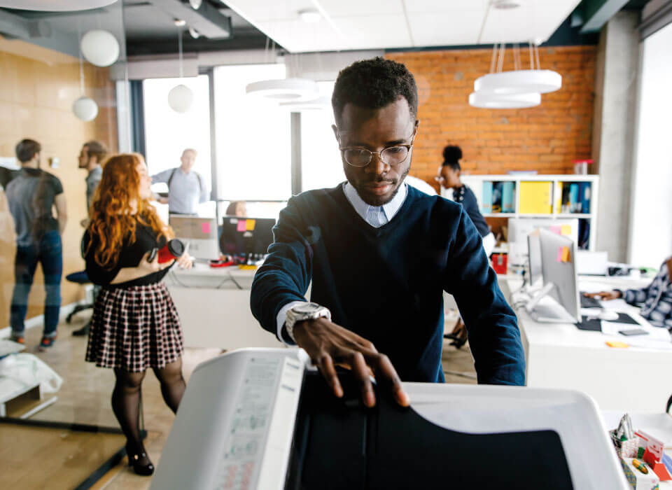 A man using printer in a startup office